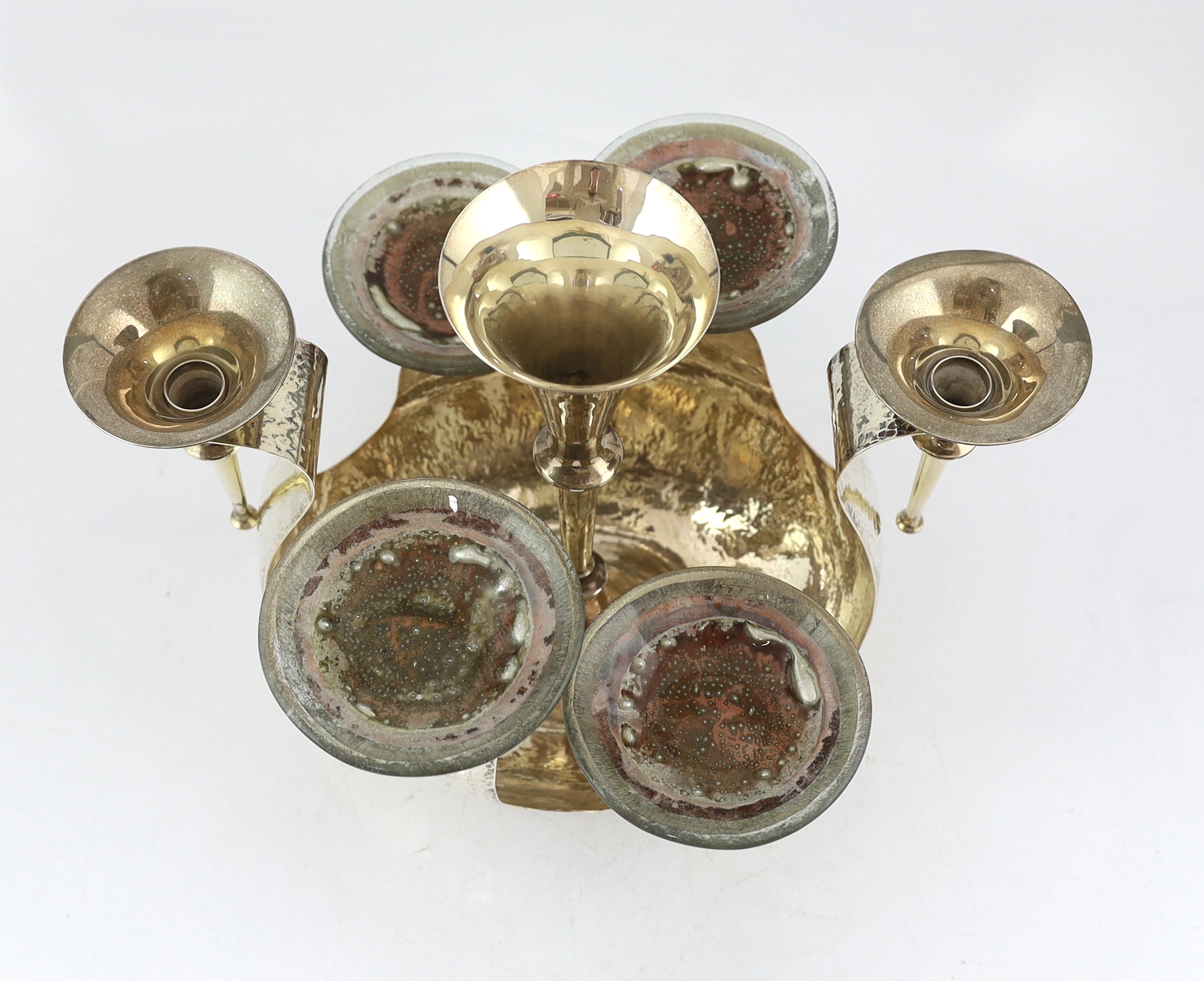 An Elizabeth II Arts & Crafts planished silver centrepiece epergne by Pruden & Smith of Ditchling, with three silver trumpet receivers and four glass dishes by Lara Aldridge